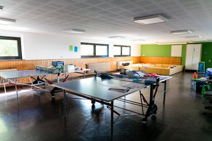 Tischtennisplatten in Raum mit Sitzgelegenheit 